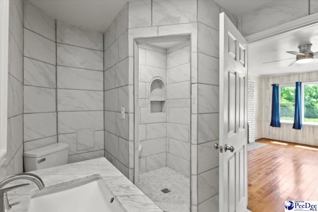 317 Thomas St, Bennettsville, SC 29512 - bathroom featuring wood finished floors, tiled shower, and ceiling fan