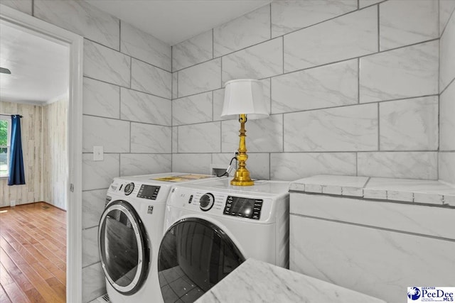 317 Thomas St, Bennettsville, SC 29512 - laundry room with wood finished floors and washing machine and clothes dryer