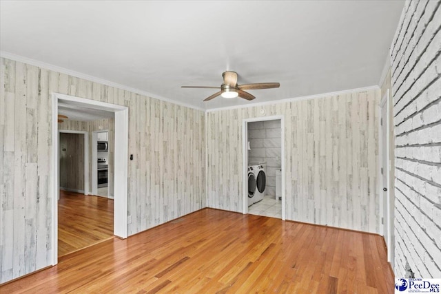 317 Thomas St, Bennettsville, SC 29512 - unfurnished living room with washer and dryer, ceiling fan, wood finished floors, and ornamental molding