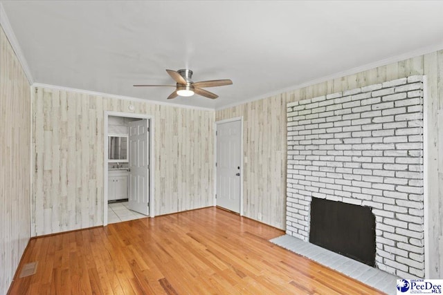 317 Thomas St, Bennettsville, SC 29512 - unfurnished living room with a ceiling fan, wood finished floors, ornamental molding, and a fireplace
