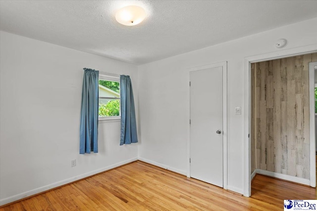 317 Thomas St, Bennettsville, SC 29512 - unfurnished bedroom with light wood-type flooring and a textured ceiling