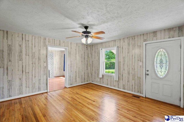 317 Thomas St, Bennettsville, SC 29512 - entrance foyer featuring wood finished floors, ceiling fan, and a textured ceiling
