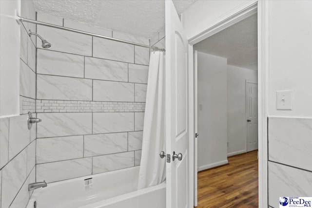 317 Thomas St, Bennettsville, SC 29512 - bathroom with shower / tub combo with curtain, a textured ceiling, and wood finished floors