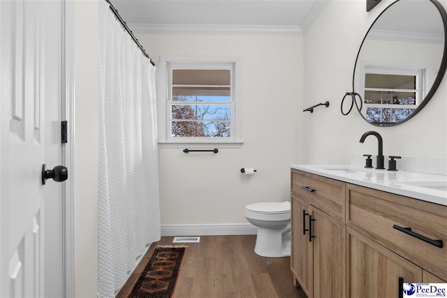 full bathroom with vanity, toilet, wood finished floors, and crown molding