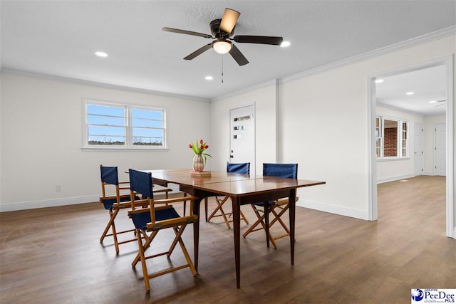 dining area featuring dark wood-style floors, baseboards, and ornamental molding