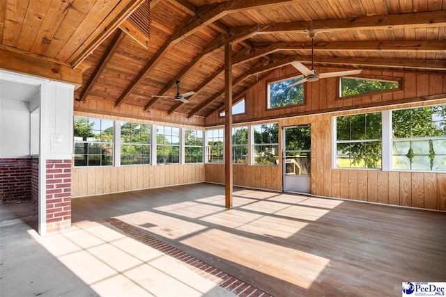 unfurnished sunroom with a healthy amount of sunlight, wooden ceiling, and a ceiling fan