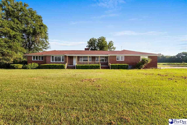 single story home with brick siding, covered porch, and a front lawn