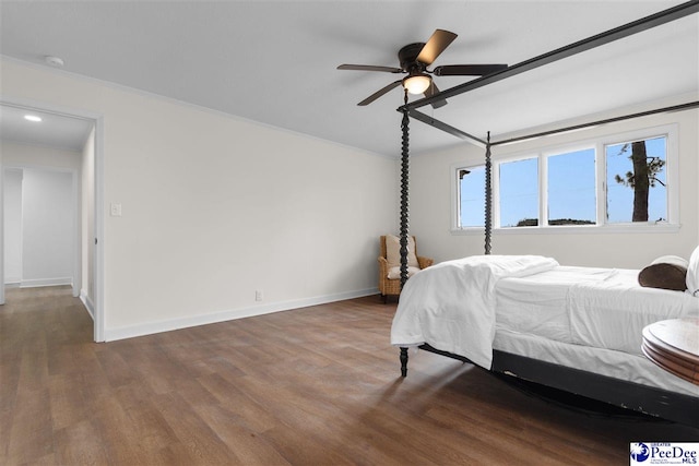 bedroom with a ceiling fan, baseboards, and wood finished floors