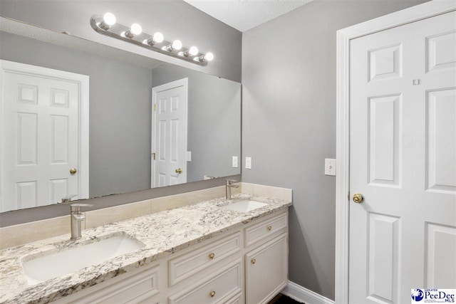 full bath featuring double vanity and a sink