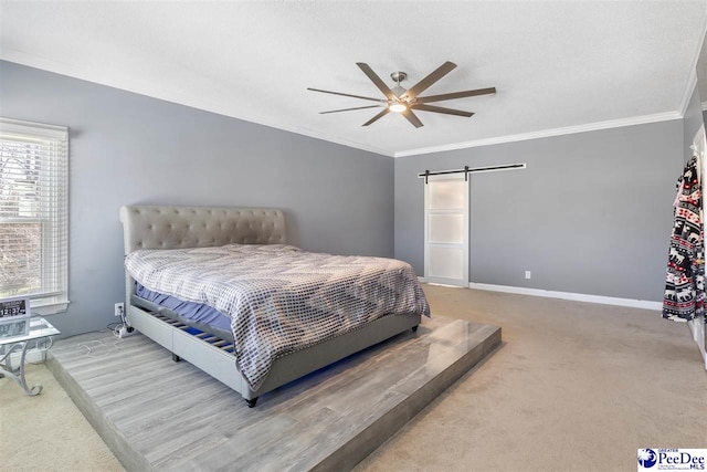 carpeted bedroom featuring baseboards, a ceiling fan, a barn door, and ornamental molding