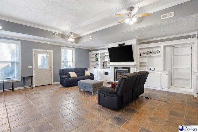 living room featuring visible vents, a glass covered fireplace, and crown molding