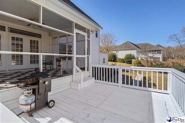 wooden deck with a sunroom