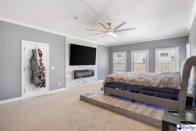 bedroom featuring baseboards, carpet floors, a fireplace, a textured ceiling, and crown molding