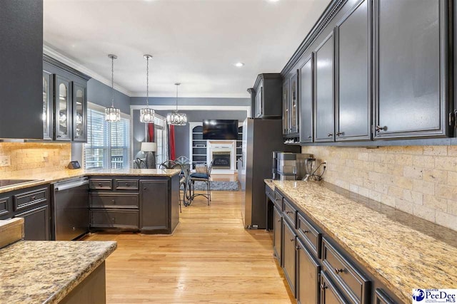 kitchen featuring light wood finished floors, stainless steel appliances, glass insert cabinets, crown molding, and decorative light fixtures