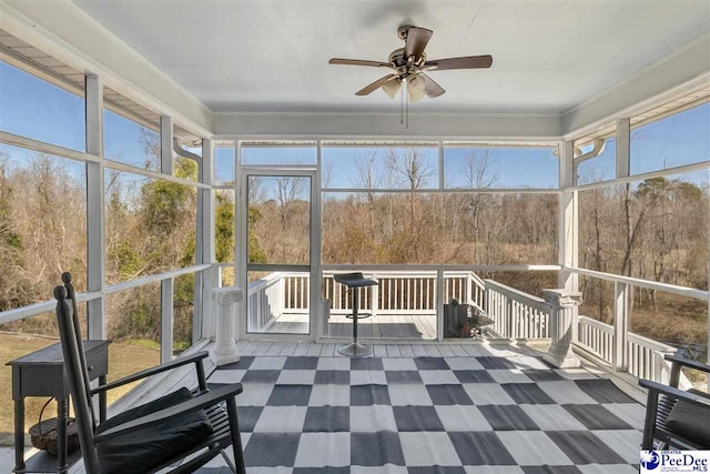 unfurnished sunroom with a ceiling fan