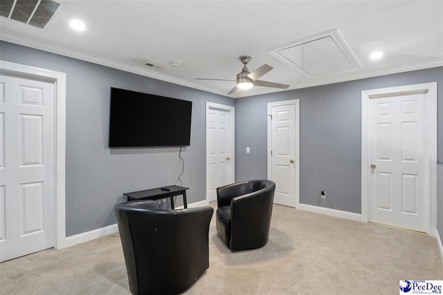 sitting room with visible vents, baseboards, light colored carpet, and attic access