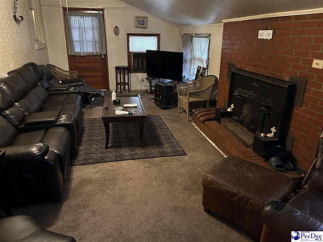 carpeted living area featuring a fireplace, lofted ceiling, and crown molding