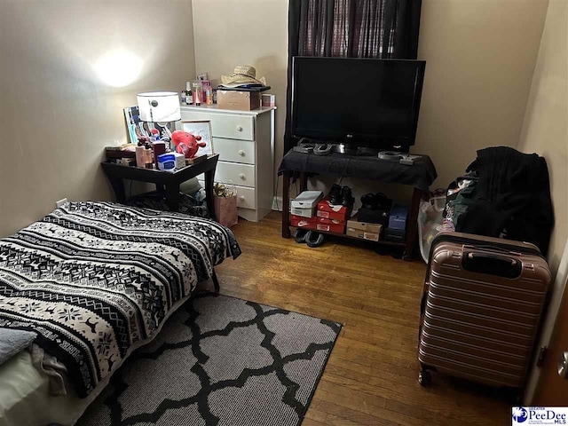 bedroom featuring wood finished floors