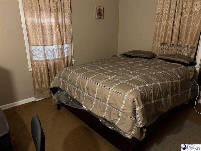 bedroom with baseboards and carpet floors