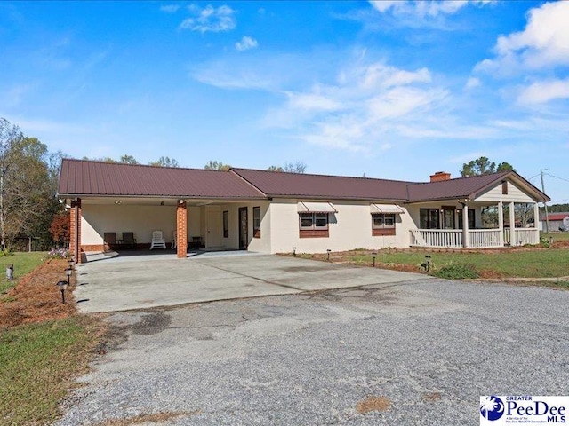 single story home featuring a carport and a porch