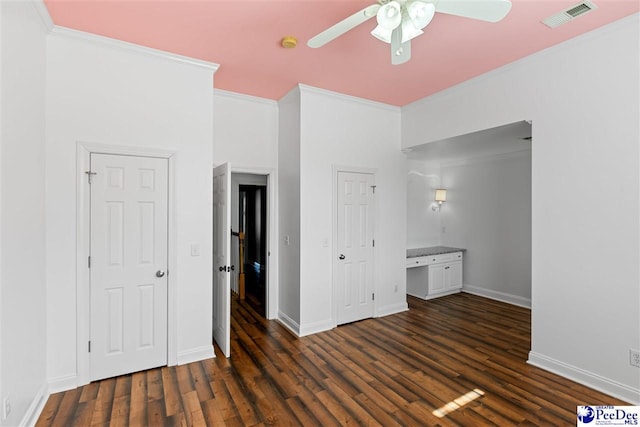 unfurnished bedroom with crown molding, visible vents, and dark wood finished floors