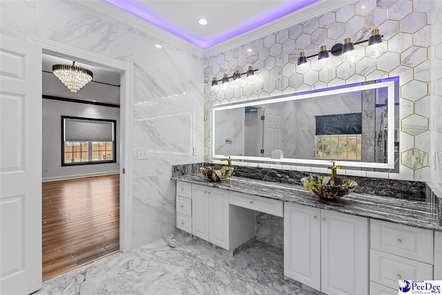 bathroom with ornamental molding, marble finish floor, vanity, tile walls, and recessed lighting