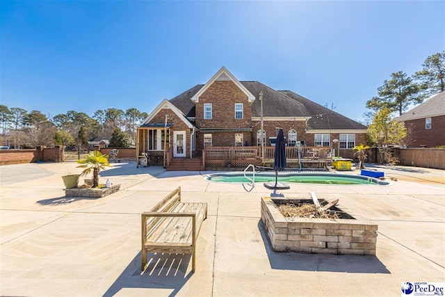 view of swimming pool featuring a patio area and fence