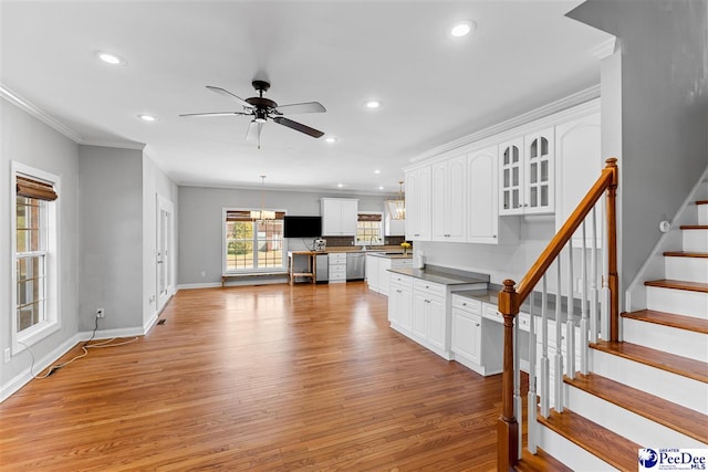 kitchen with light wood-style flooring, glass insert cabinets, white cabinets, and dishwasher