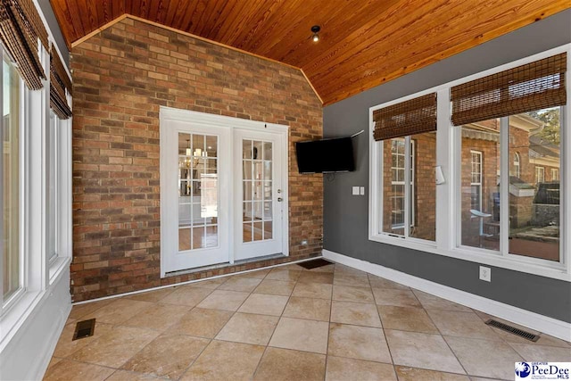 entrance to property with a patio area, visible vents, and french doors