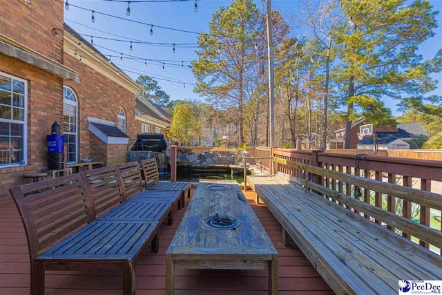 wooden deck with fence and outdoor dining space