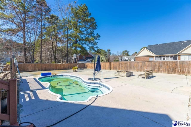 view of swimming pool featuring a patio, an outdoor fire pit, a fenced backyard, and a fenced in pool