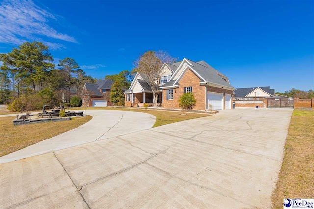 view of front of home with a front yard, brick siding, and driveway