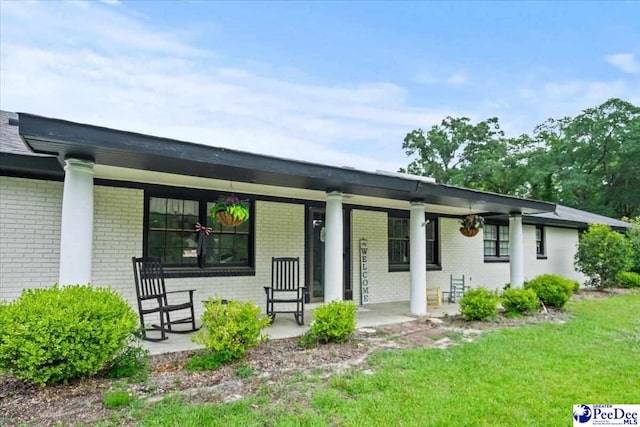 106 Min Lou Cir, Darlington, SC 29532 - view of front of property featuring brick siding, a porch, and a front lawn