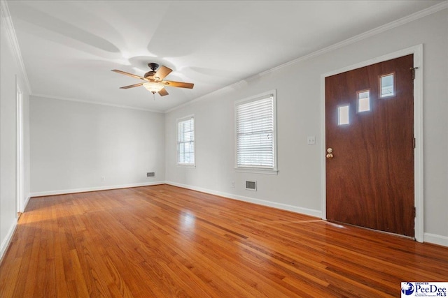 entryway featuring crown molding, ceiling fan, and wood-type flooring