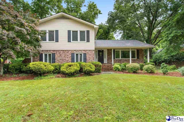 tri-level home with a front lawn