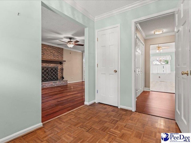 interior space with baseboards, a textured ceiling, and crown molding