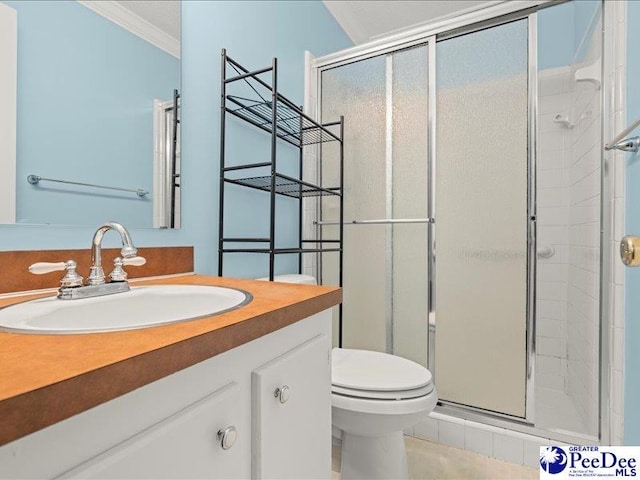 full bathroom with toilet, vanity, a shower stall, and crown molding