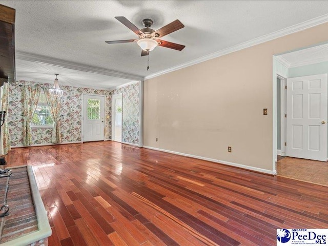 unfurnished living room with crown molding, ceiling fan, wood finished floors, and baseboards