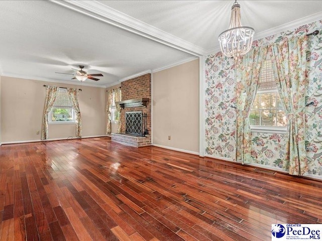 unfurnished living room featuring a fireplace, wood finished floors, and crown molding