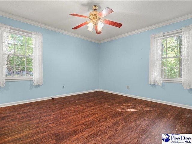empty room featuring crown molding, ceiling fan, baseboards, and dark wood finished floors