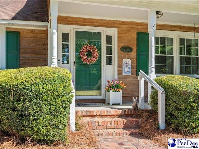 view of exterior entry with covered porch