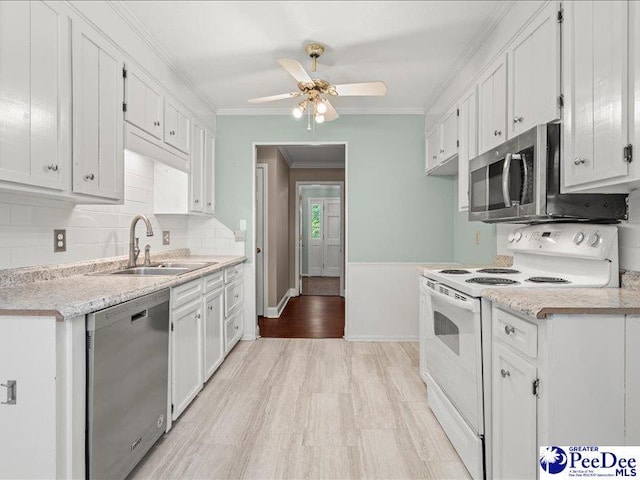 kitchen featuring ornamental molding, a ceiling fan, a sink, and appliances with stainless steel finishes