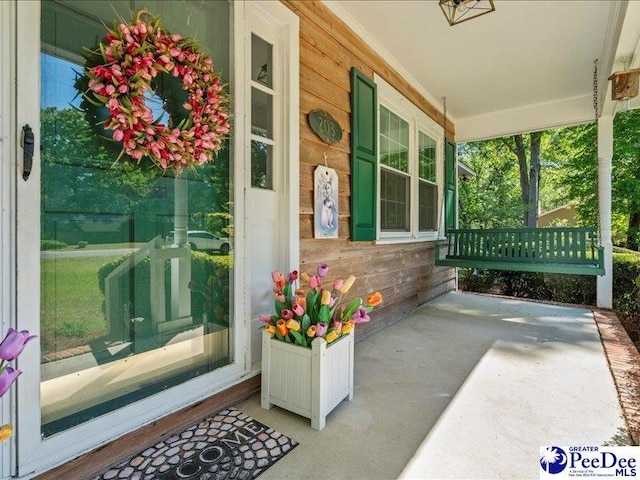 entrance to property featuring covered porch
