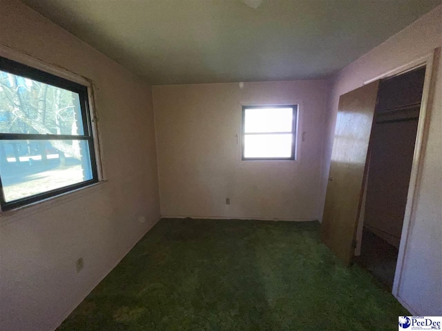 unfurnished bedroom featuring a closet and carpet flooring