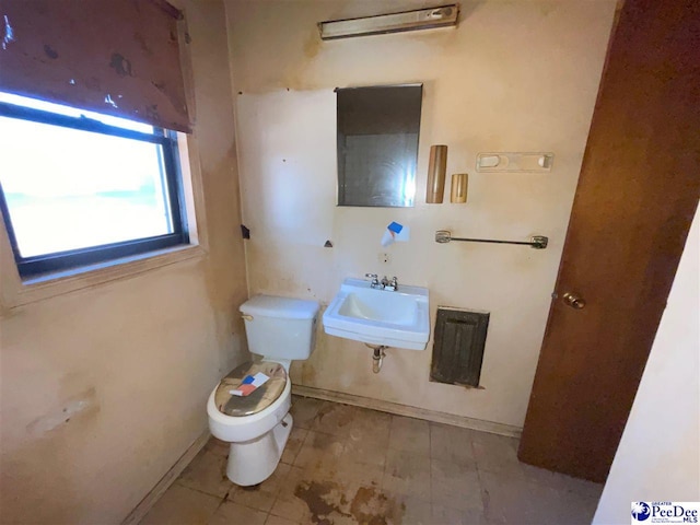 half bath featuring a sink and toilet