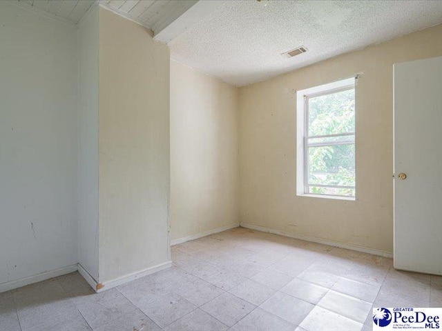 spare room featuring a textured ceiling