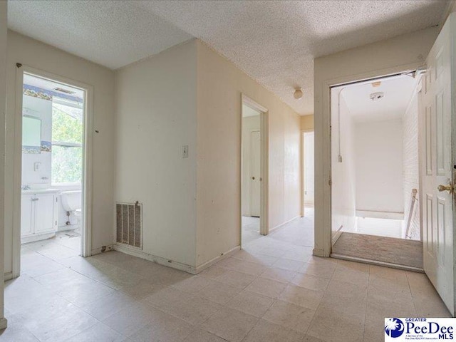 corridor with a textured ceiling