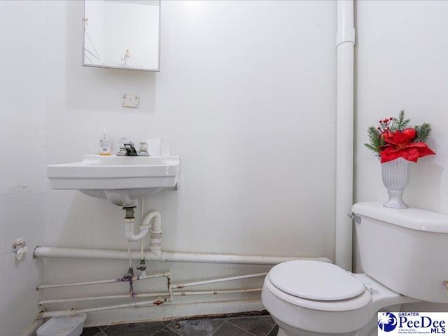 bathroom featuring tile patterned flooring, sink, and toilet