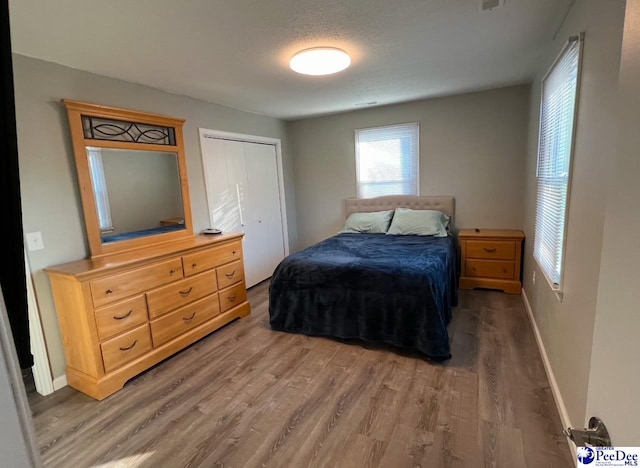 bedroom featuring hardwood / wood-style flooring and a closet