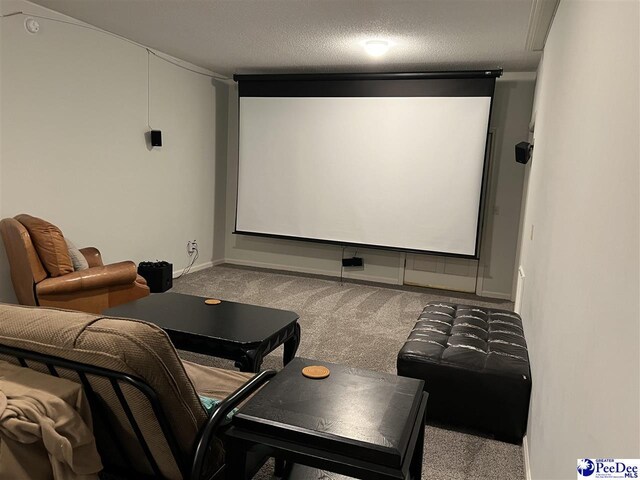 carpeted cinema featuring a textured ceiling and baseboards